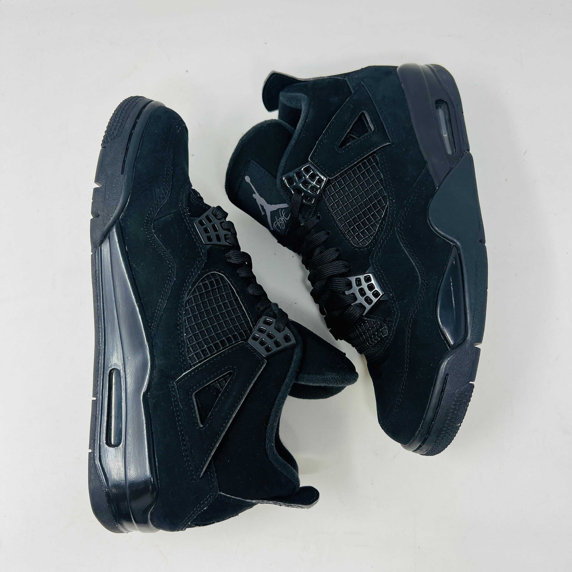 Jordan 4 Retro Black Cat (2020) sneakers in black, condition 8.5/10, displayed on their original box.