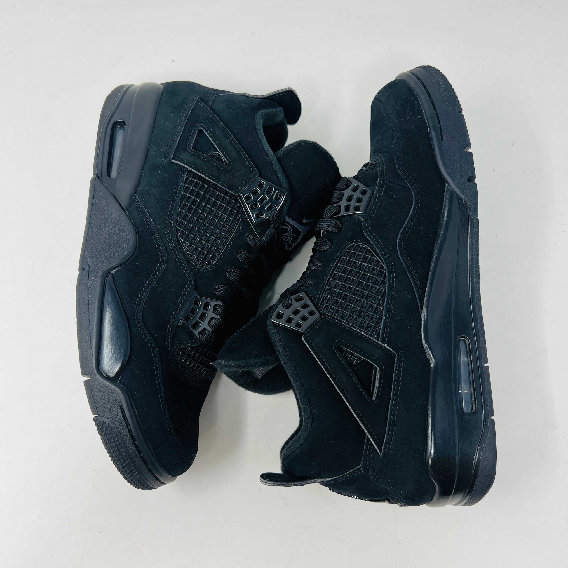 Jordan 4 Retro Black Cat (2020) sneakers in black, condition 8.5/10, displayed on their original box.