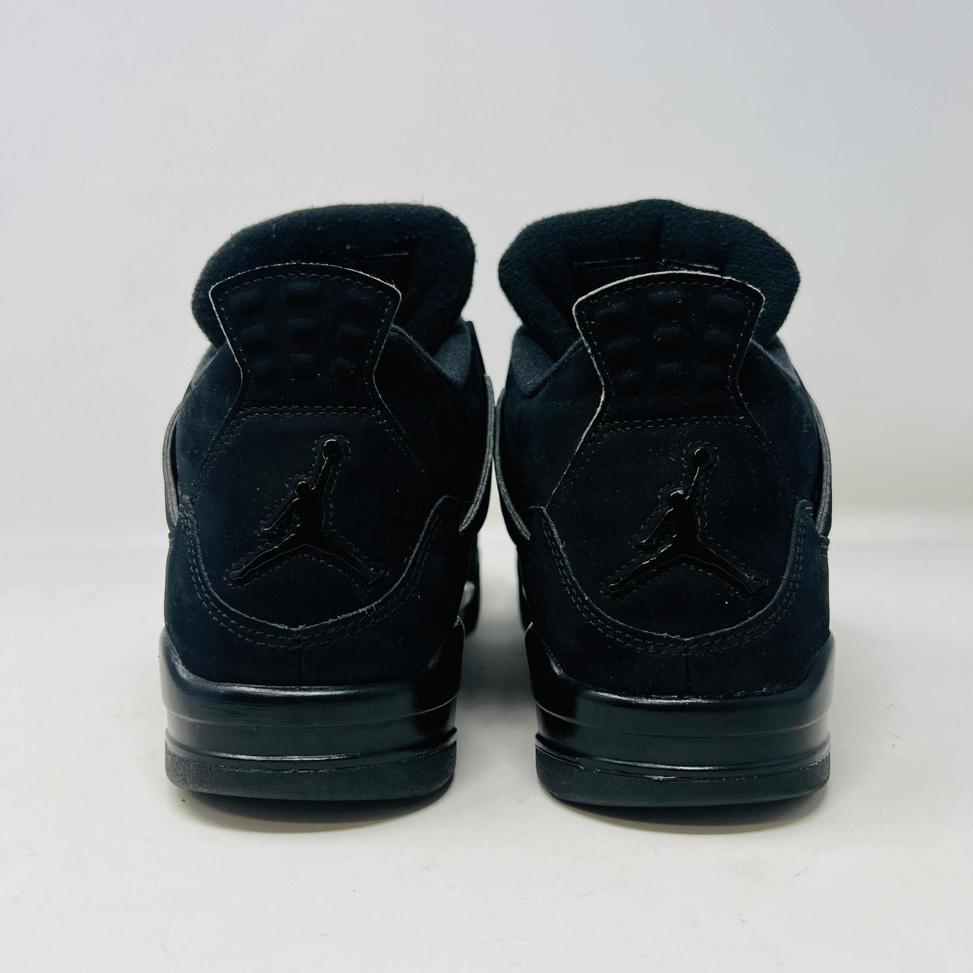 Jordan 4 Retro Black Cat (2020) sneakers in black, condition 8.5/10, displayed on their original box.
