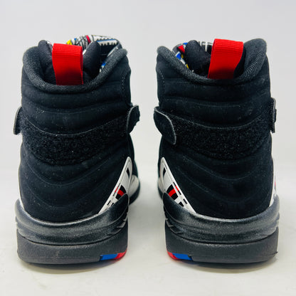 A Jordan 8 Retro Playoffs (2023) shoe, black and red with gray/red accents, features a high-top design with a strap, textured sole with blue hints, and clean uppers. Displayed on its Nike Air box in good condition, the label reveals size and Jordan brand details.