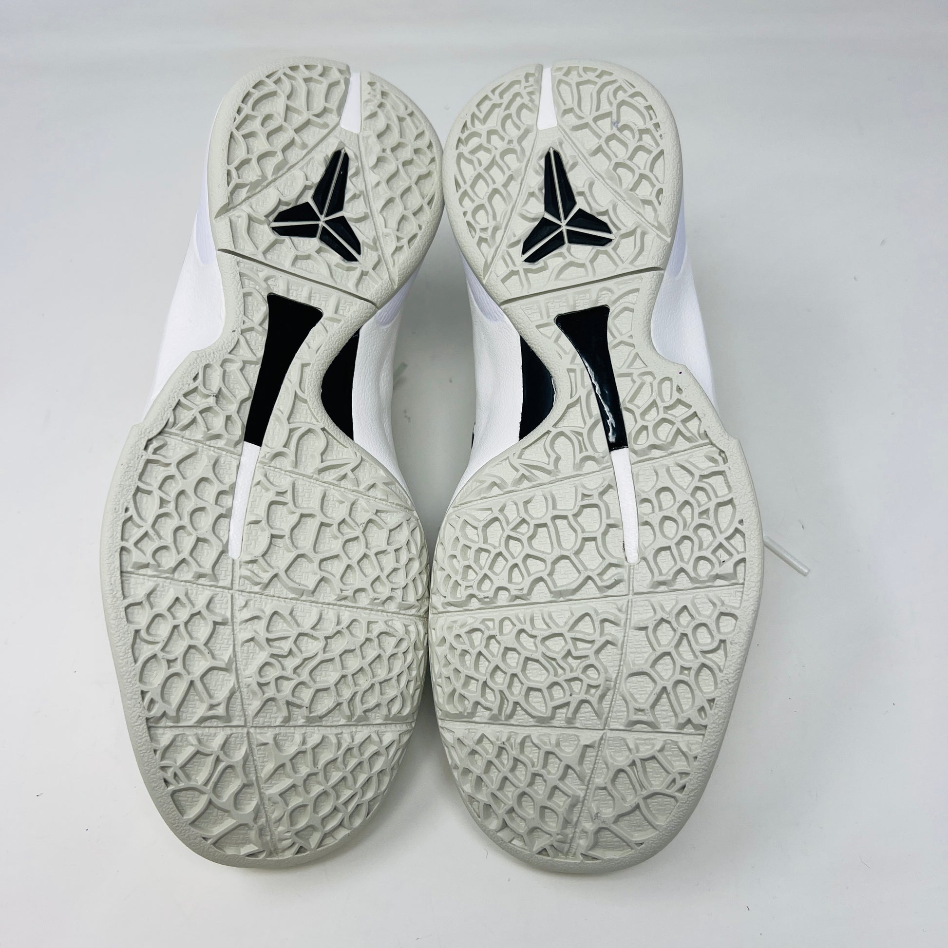 The fresh white Nike Kobe 6 Sail All-Star (GS) athletic shoe, showcasing a textured design and black swoosh logo, is presented on an orange box. Inside are plastic-wrapped accessories and extra laces for versatile style in 2024.