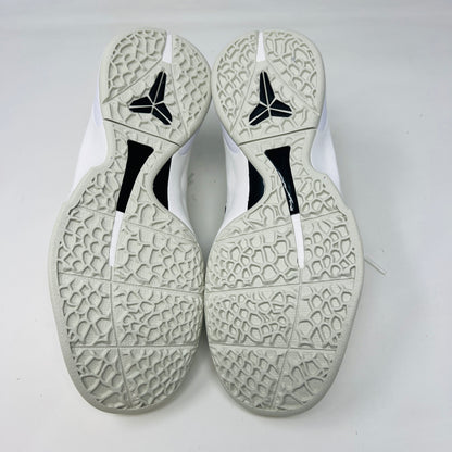 The fresh white Nike Kobe 6 Sail All-Star (GS) athletic shoe, showcasing a textured design and black swoosh logo, is presented on an orange box. Inside are plastic-wrapped accessories and extra laces for versatile style in 2024.