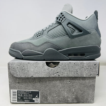 The Jordan 4 Retro SE Paris Olympics Wet Cement sneaker is displayed on its matching gray textured box, showcasing both in pristine condition. It features clean uppers with smooth and mesh textures, a visible air unit, and a size label with US, UK, and EU measurements.