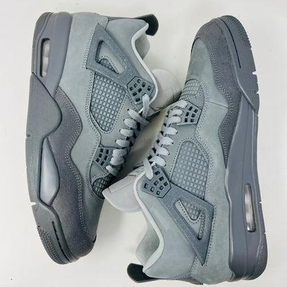 The Jordan 4 Retro SE Paris Olympics Wet Cement sneaker is displayed on its matching gray textured box, showcasing both in pristine condition. It features clean uppers with smooth and mesh textures, a visible air unit, and a size label with US, UK, and EU measurements.
