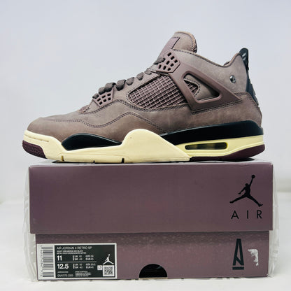 The Jordan 4 Retro SP A Ma Maniére Violet Ore sneakers sit elegantly on their matching box, featuring unique netting and black accents. The box displays size and brand details, emphasizing its immaculate condition.