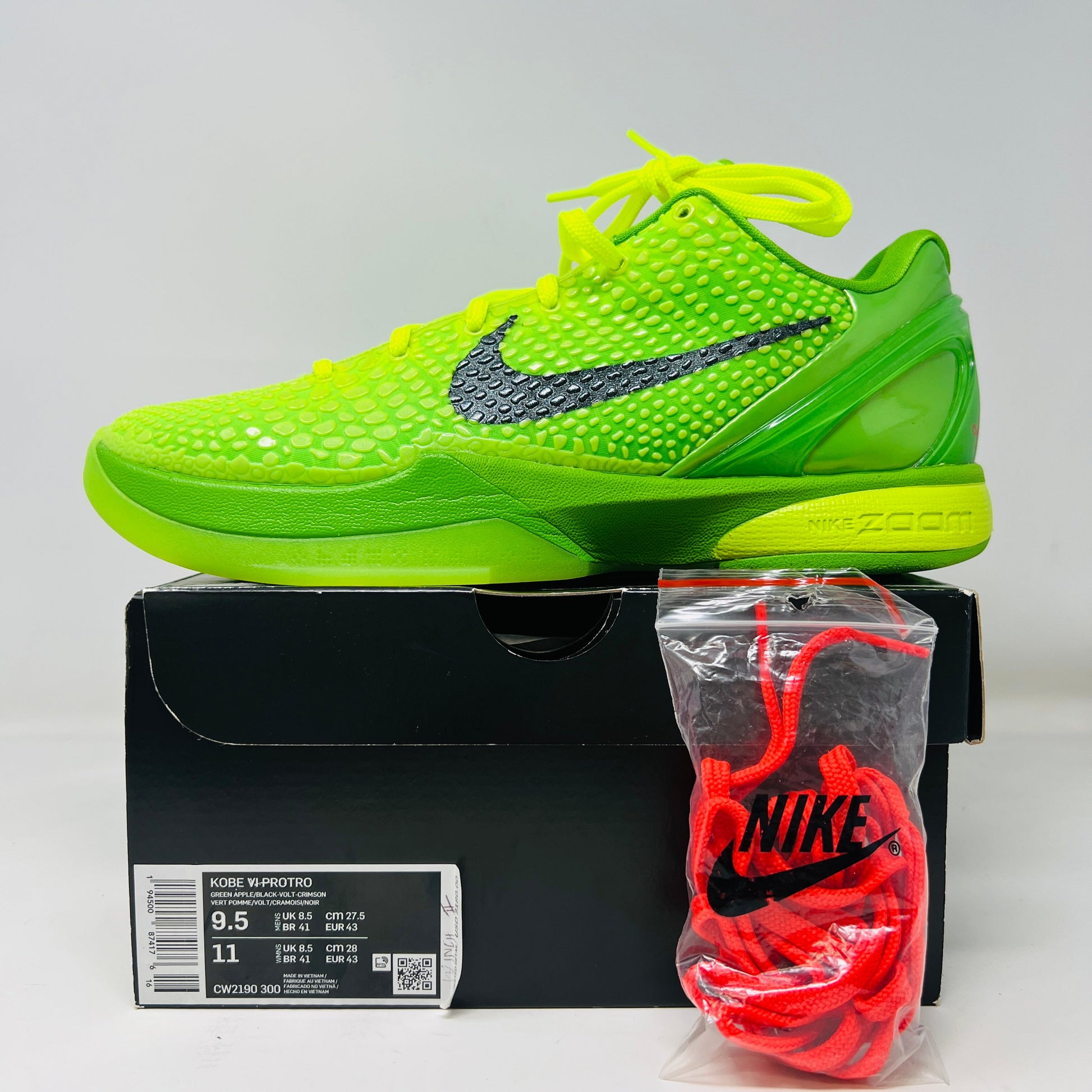Nike Kobe 6 Protro Grinch 2020 sneakers with extra red laces on a box.