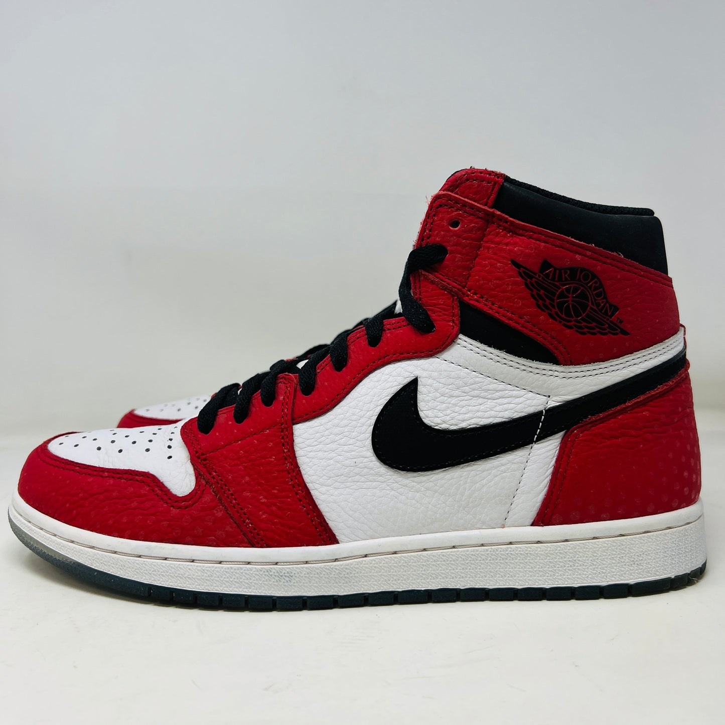 Jordan 1 Retro High Spider-Man Origin Story 2018 with red and white clean uppers, slight wear, and extra red laces.