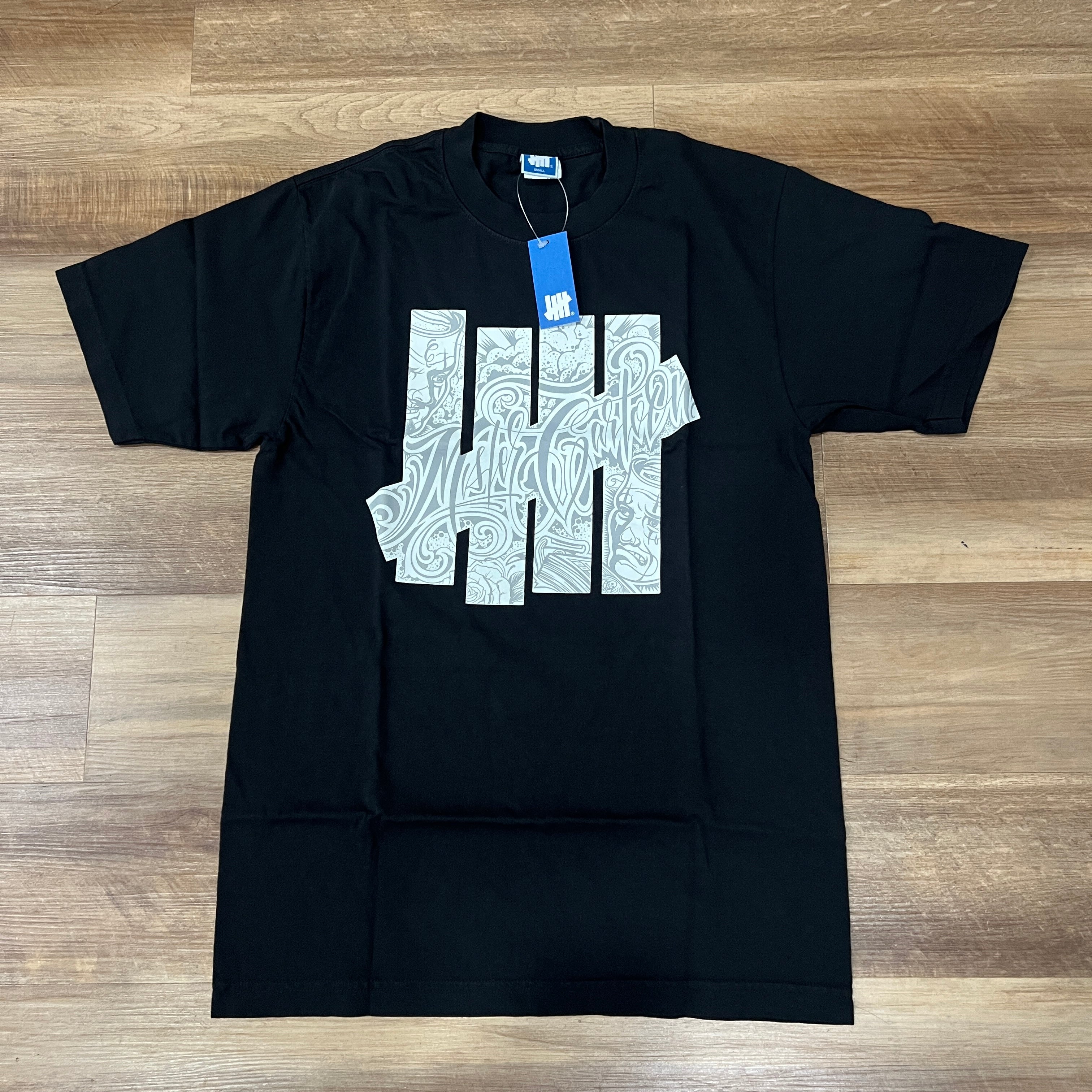 Undefeated x Mister Cartoon S/S Tee Black – Holy Ground