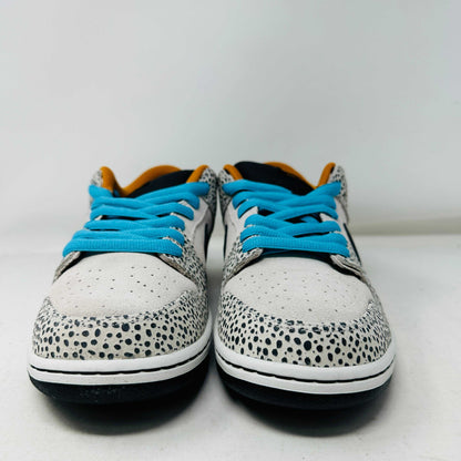 The Nike SB Dunk Low Electric Pack Olympic Safari, a new 2024 release, showcases a speckled gray and white design with a black swoosh, blue laces, and orange lining, elegantly set upon its box against a plain backdrop.
