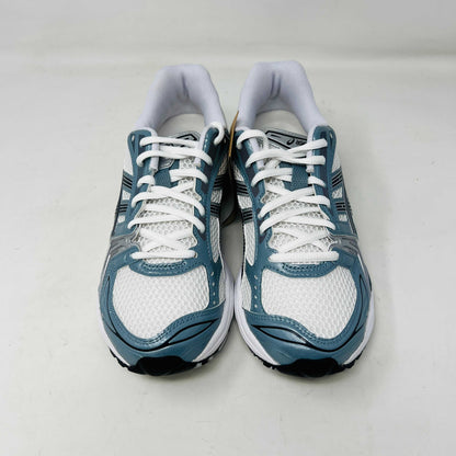 The ASICS Gel-Kayano 14 White Fjord Grey running shoe stands on a brown ASICS box, featuring intricate designs, a breathable mesh upper, and a cushioned thick sole for support. Its 100% authentic.