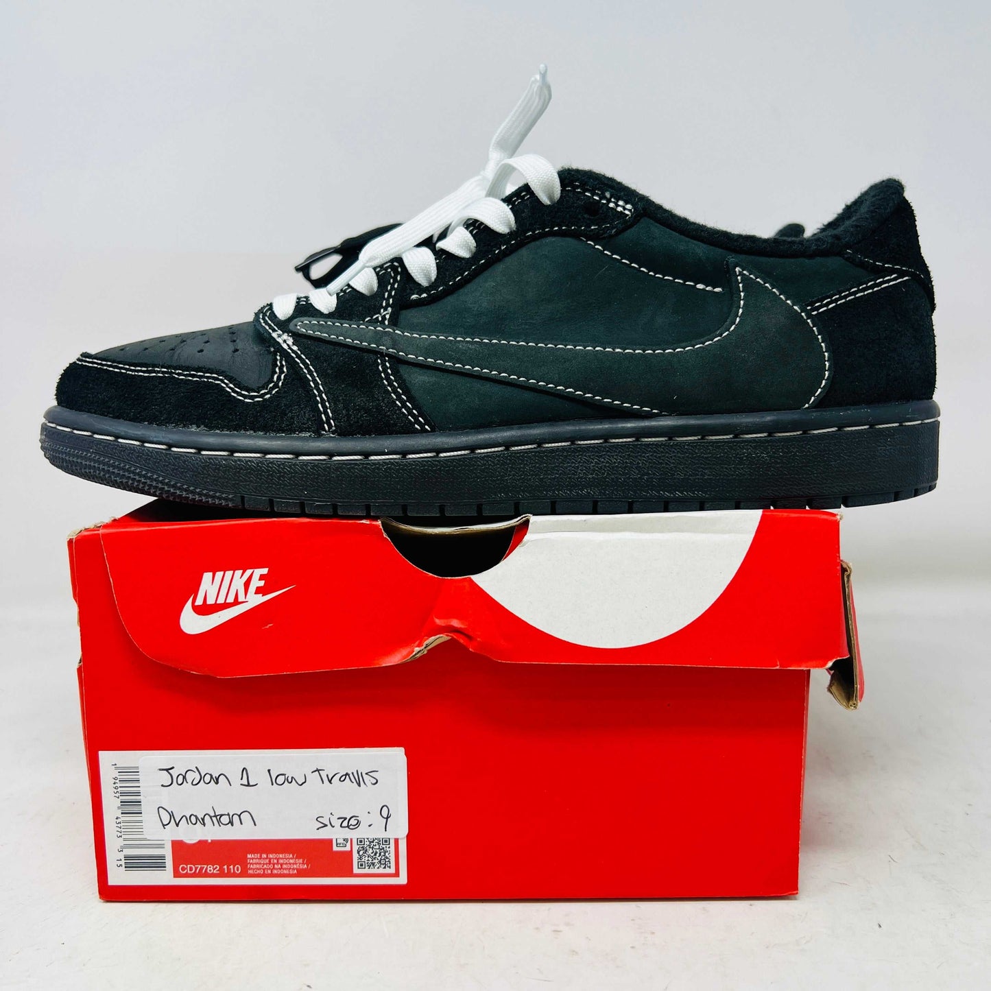 Jordan 1 Retro Low OG Travis Scott Black Phantom sneaker on red Nike box size 9