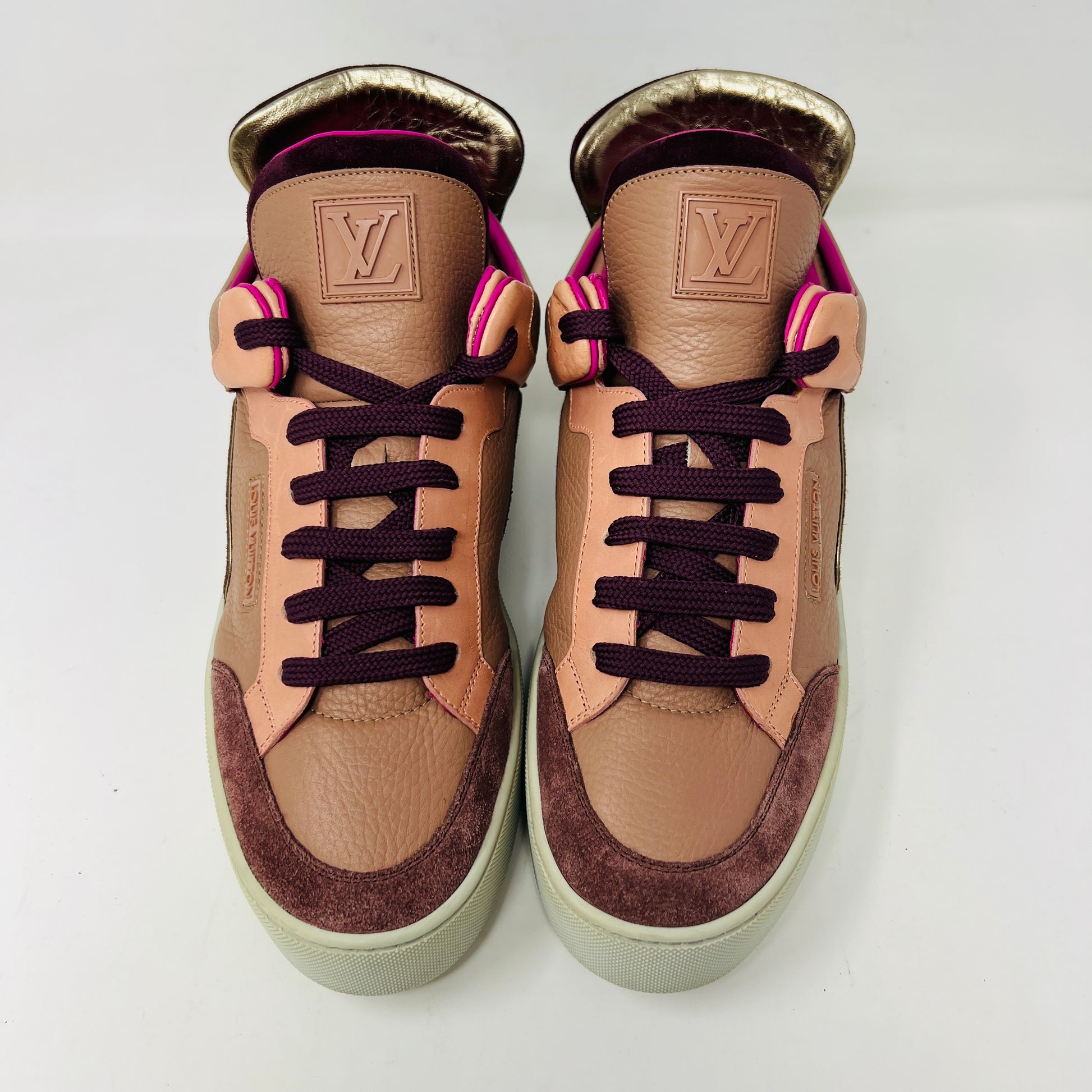 The Louis Vuitton Don Kanye Patchwork high-tops showcase brown and pink leather details with dark brown laces and a logo on the tongue. The white soles have a pink touch at the collar, ideal for size 7 fashionistas seeking extra flair.