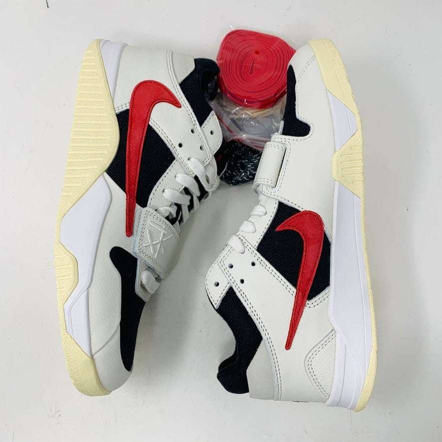 Authentic Jordan Jumpman Jack TR Travis Scott University Red shoes with white and black uppers feature red swoosh logos, resting sideways on a white surface. The soles have a slightly yellowed hue. Brand new red shoelaces are packaged in plastic, placed between the shoes, ready to complete this 2024 style statement.