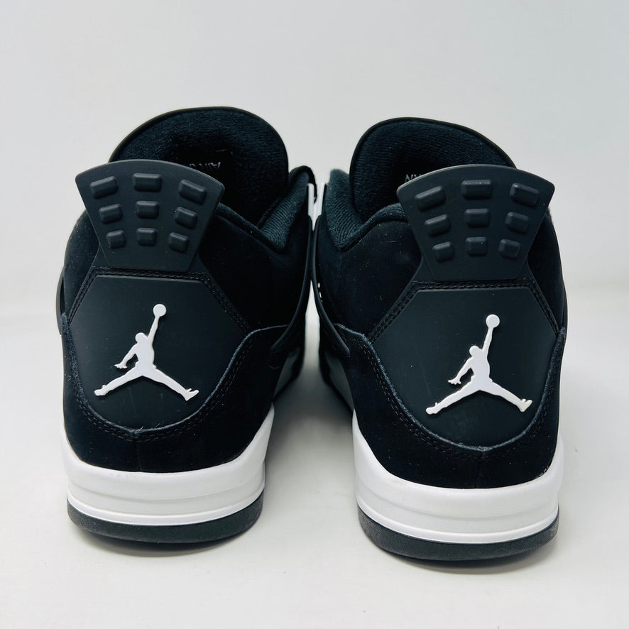 The Jordan 4 Retro White Thunder sneakers, featuring black with white accents and mesh paneling, are displayed on a white shoebox. The size label shows size 13 (UK 14.5). These lightly worn kicks enhance their character, while the box condition remains excellent.