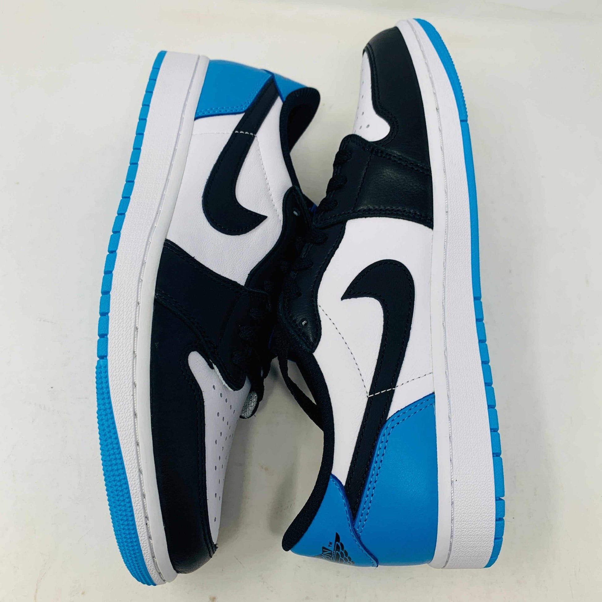 Jordan 1 Low OG Powder Blue sneakers with blue accents and extra laces, 2022 model.