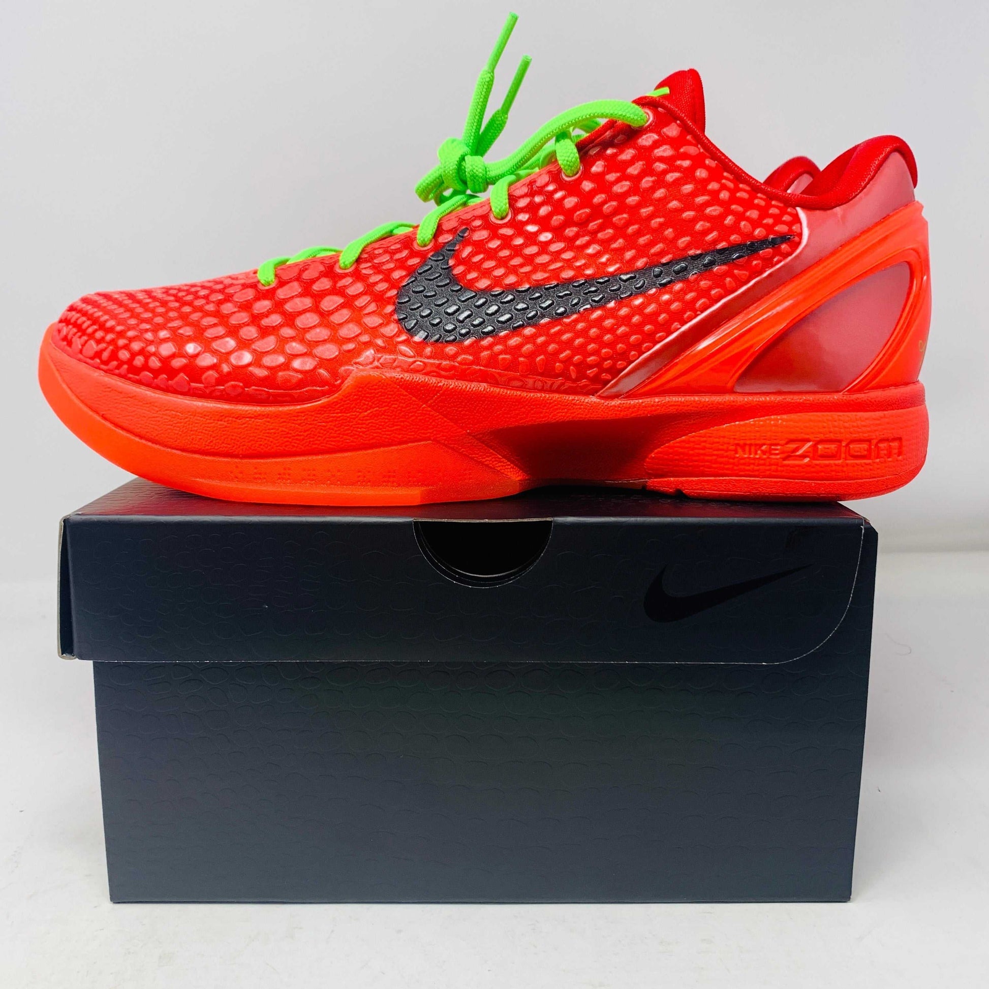 Nike Kobe 6 Protro Reverse Grinch red sneakers on black box, green laces, 2023 release.