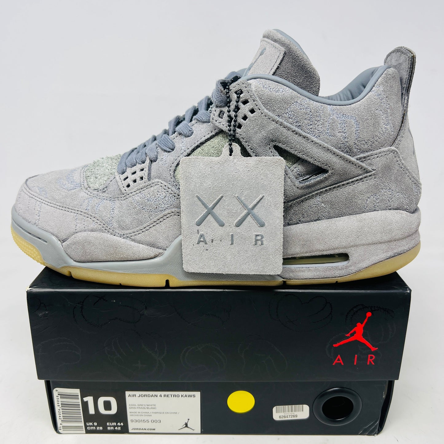 Jordan 4 Retro Kaws gray suede sneakers with hang tag on black box, size 10, 2017 edition