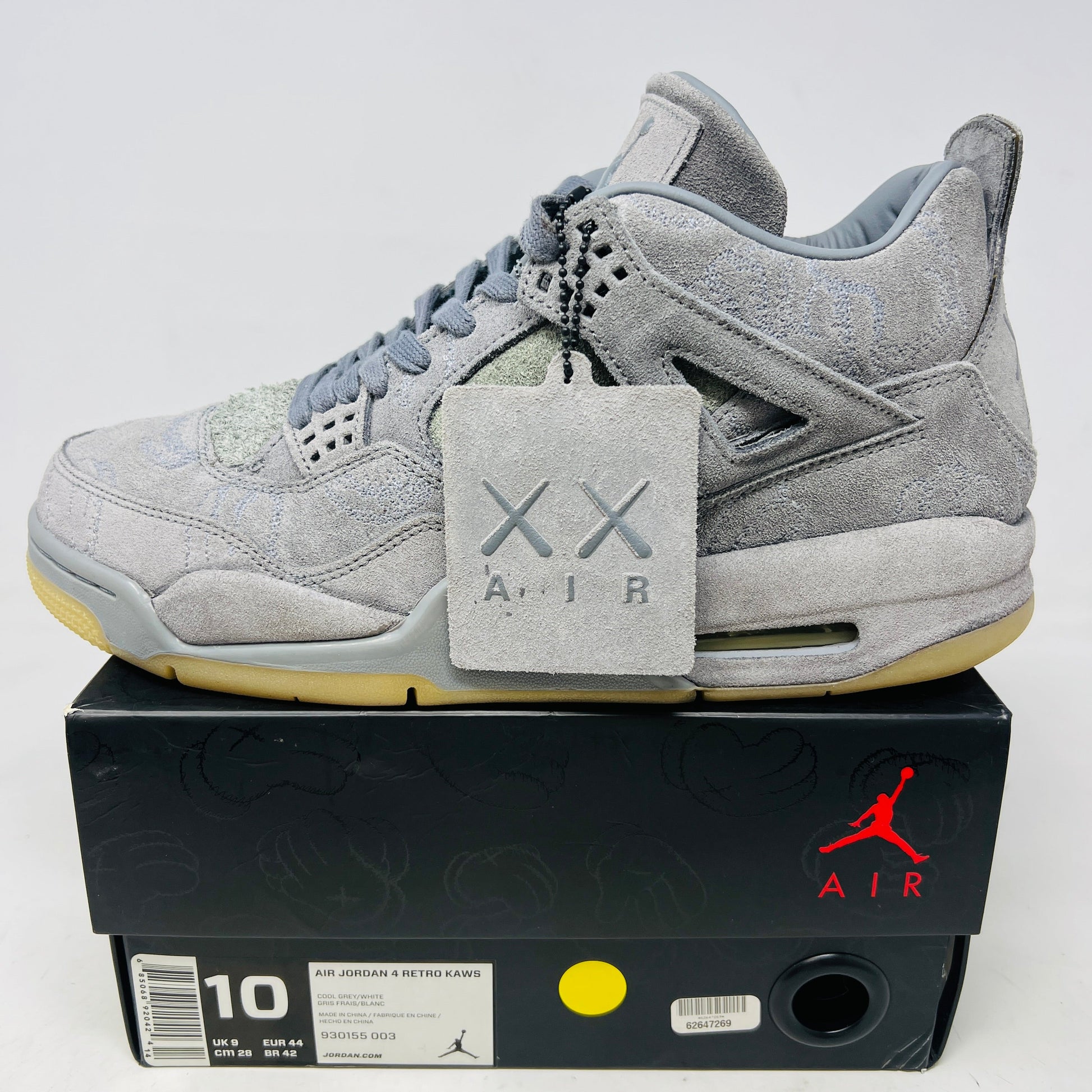 Jordan 4 Retro Kaws gray suede sneakers with hang tag on black box, size 10, 2017 edition
