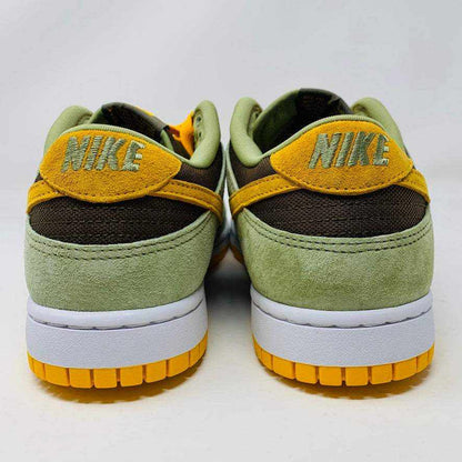 Nike Dunk Low Dusty Olive sneakers on an orange box.