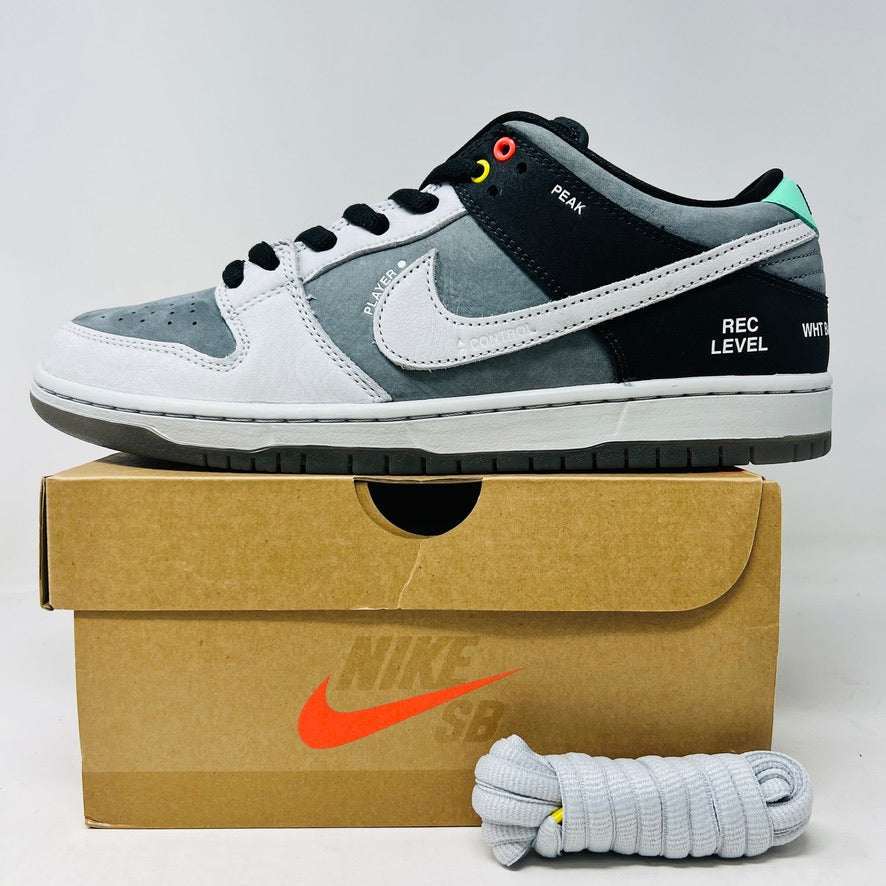 Nike SB Dunk Low sneaker in grey, white, and black with colorful eyelets and text detailing, displayed with extra grey laces and box.