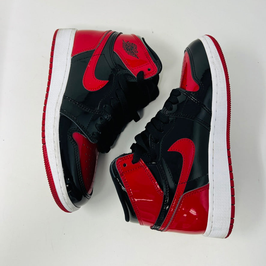 Jordan 1 Retro High OG Patent Bred sneakers with red laces and original box.