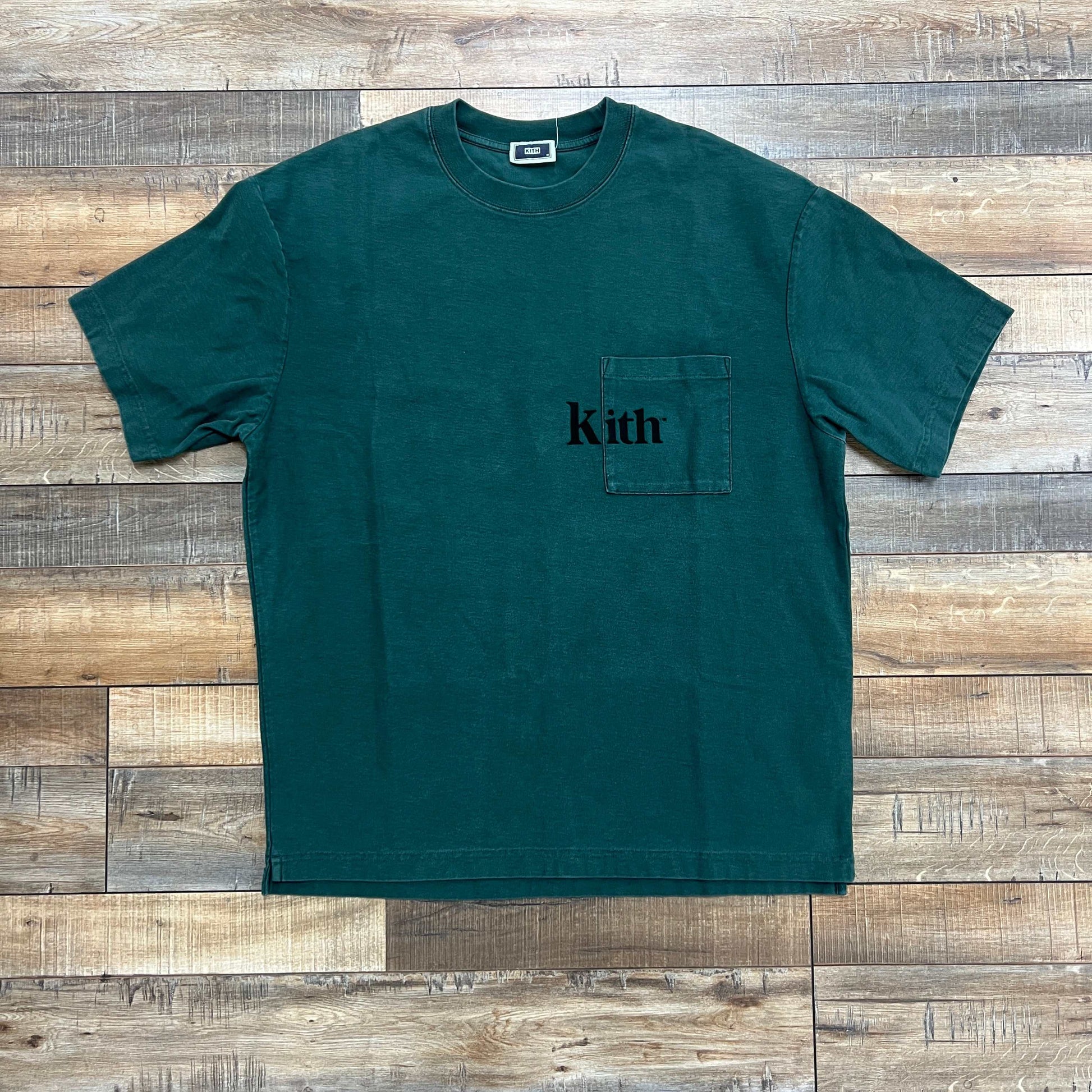 Preowned Kith Quinn Tee Rhythm green T-shirt with pocket logo on wooden background