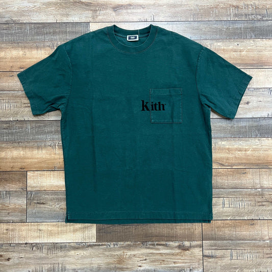 Preowned Kith Quinn Tee Rhythm green T-shirt with pocket logo on wooden background