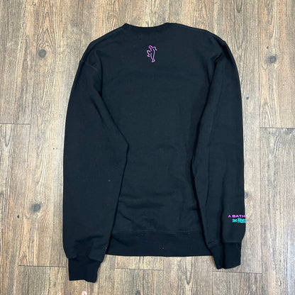 This pre-owned black A BATHING APE X THE FRESH PRINCE sweatshirt by Bape features a vibrant ape graphic with sunglasses, The Fresh Prince in a speech bubble, and purple and green logo accents, all displayed on a wooden floor.