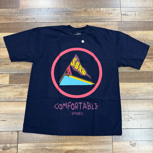 Savior Saucony Tee Navy with graphic design on wooden floor.