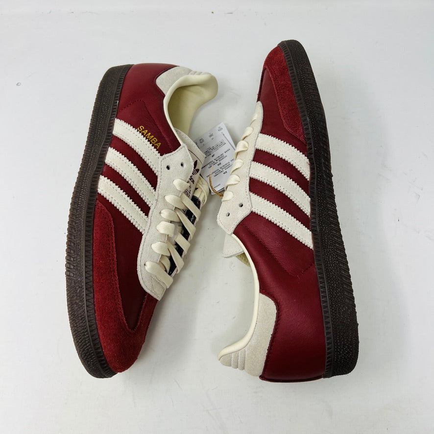 The adidas Samba OG Preloved Ruby Cream White sneaker from Adidas, elegantly displayed on a blue box, comes in size 10½. Featuring white stripes and extra red laces for customization, its ready to step confidently into 2024.