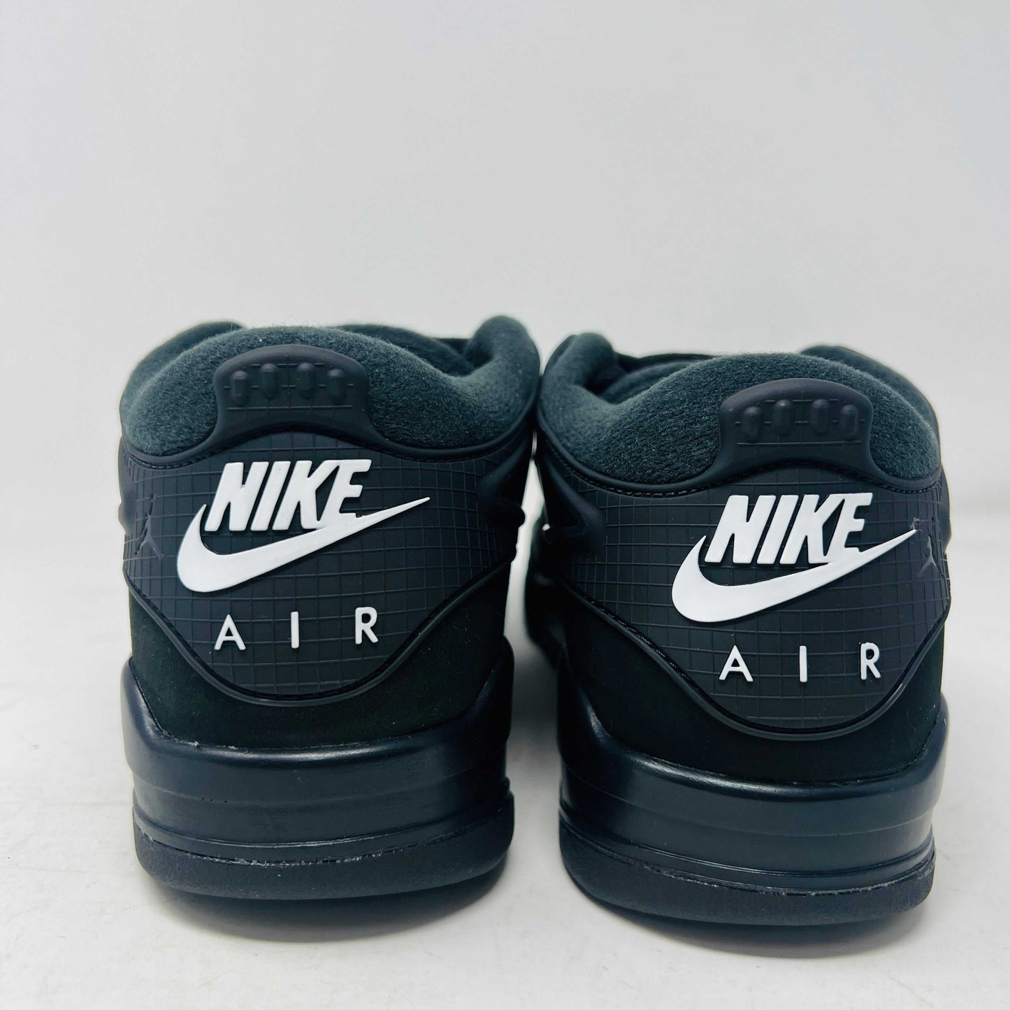 Jordan 4 RM Black Cat sneaker with sleek black design and premium leather.