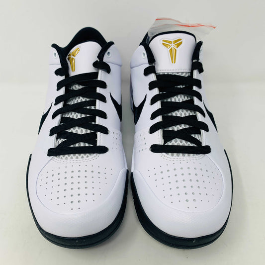 The Nike Kobe 4 Protro Mambacita Gigi shoe, featuring a black swoosh, black accents, and a checkered heel pattern, is displayed on a white box with a gold Nike logo. The box also includes extra laces.
