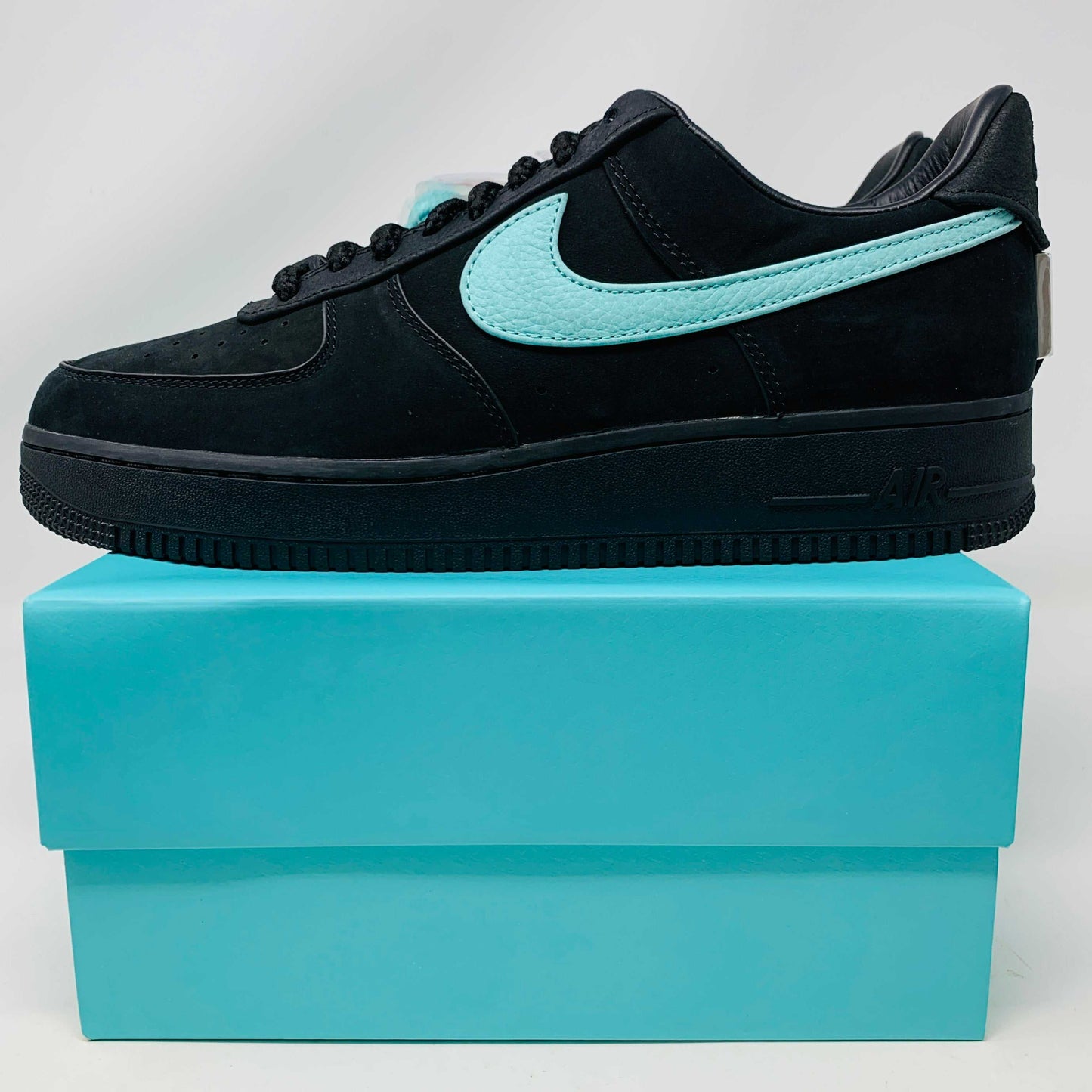 Nike Air Force 1 Low Tiffany & Co. 1837 sneakers in black with Tiffany blue swoosh, on matching blue box.
