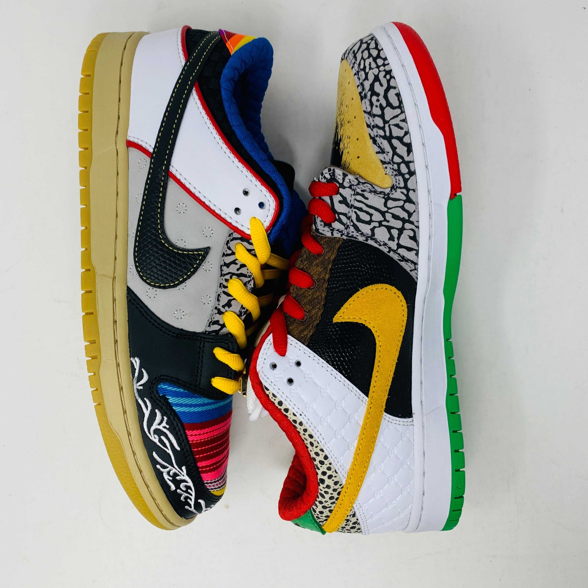 The Nike SB Dunk Low What the Paul is a 2021 authentic sneaker featuring varied textures and patterns like elephant print, a gradient swoosh, red laces, and comes in a colorful green, yellow, and white Nike SB box.