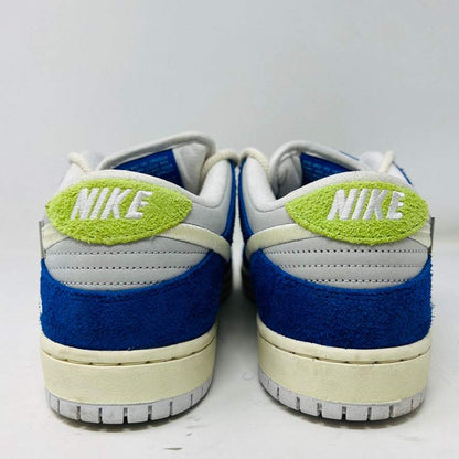 The back view of the size 11 Nike SB Dunk Low Pro Fly Streetwear Gardenia sneakers shows blue and green accents with a NIKE logo on a textured heel. These authentic shoes feature a white sole and are set against a plain white backdrop.