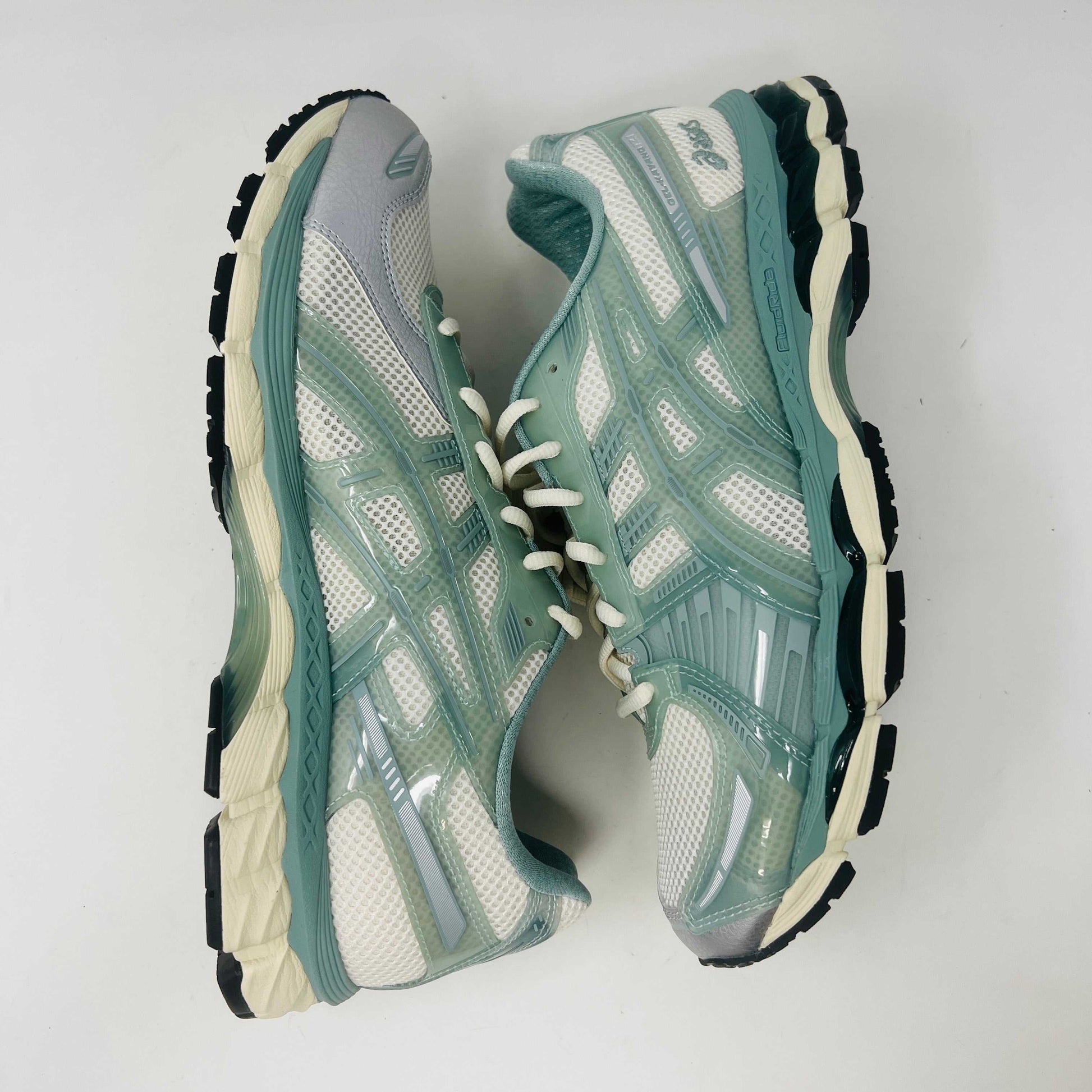 The ASICS Gel-Kayano 12.1 Kith Cream Sage sneakers in pastel green and white feature a breathable mesh design. Theyre accompanied by two packs of extra laces (green and white with black speckles), offering versatile styling for your 100% authentic needs.