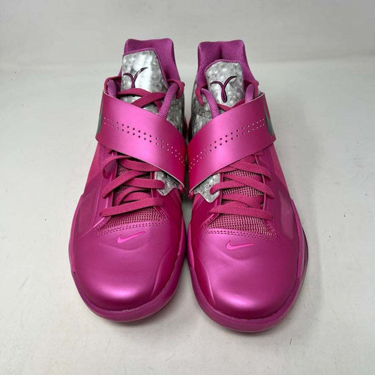 Authentic pink Nike KD 4 Aunt Pearl (2024) shoe with a black swoosh and a sleek silver and white design near the laces, elegantly displayed on a black shoebox showing size and model details.