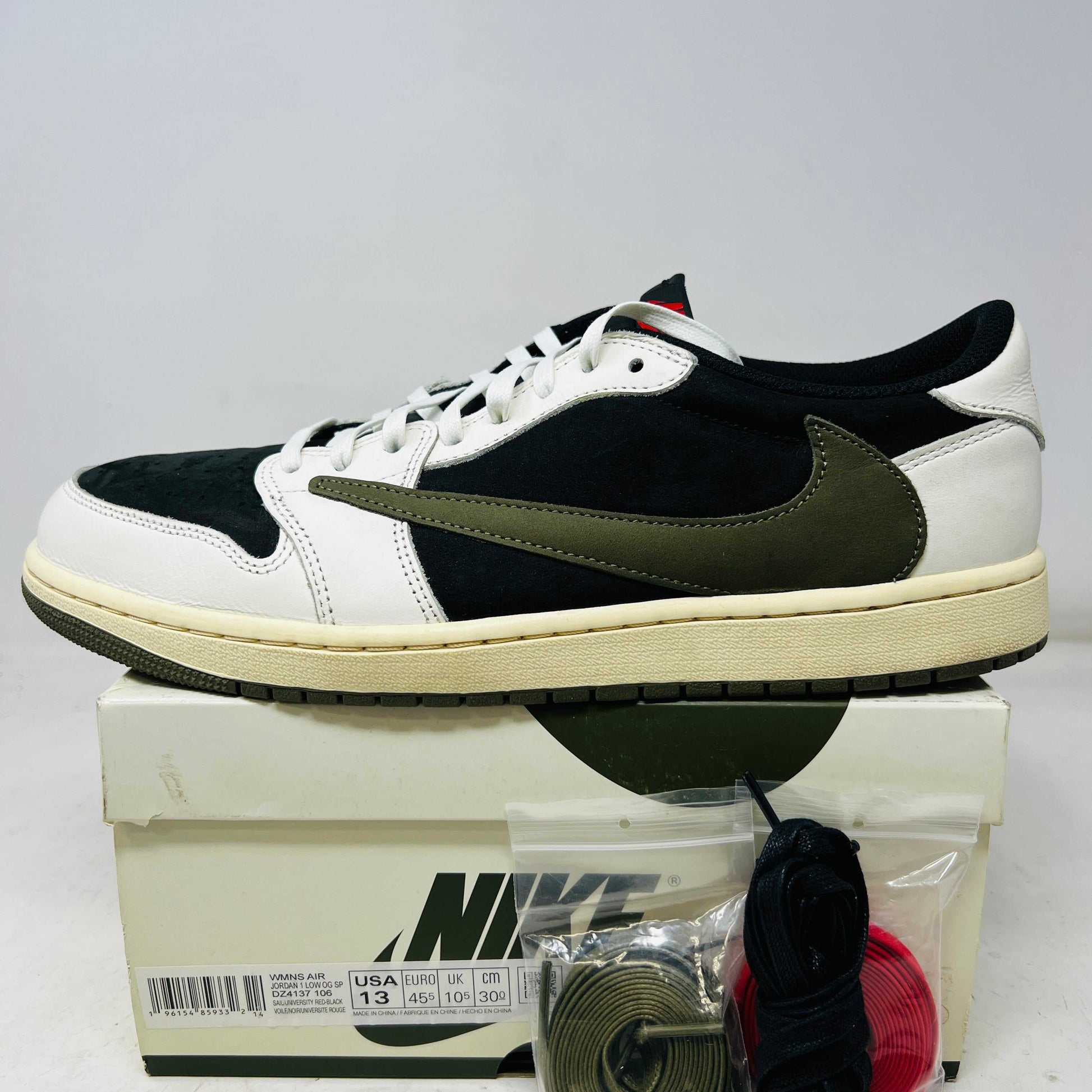 Jordan 1 Retro Low OG Travis Scott Olive women's sneaker side view on box with extra laces and minimal heel wear