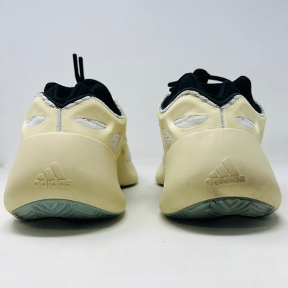 The adidas Yeezy 700 V3 Azael features a futuristic design with a black mesh upper, white and beige sculpted overlays, and an intricate lacing system. It has a sleek, modern look set against a plain white background, showing minimal wear for that fresh out-of-the-box condition.