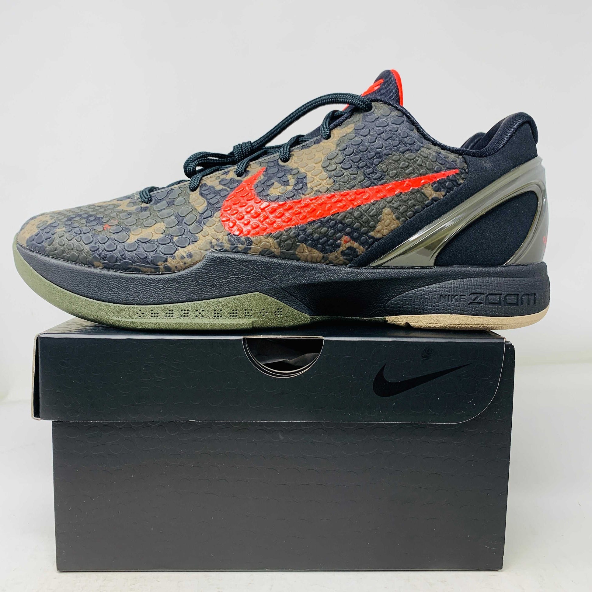 Nike Kobe 6 Protro Italian Camo (2024) sneaker with red Swoosh on display box.