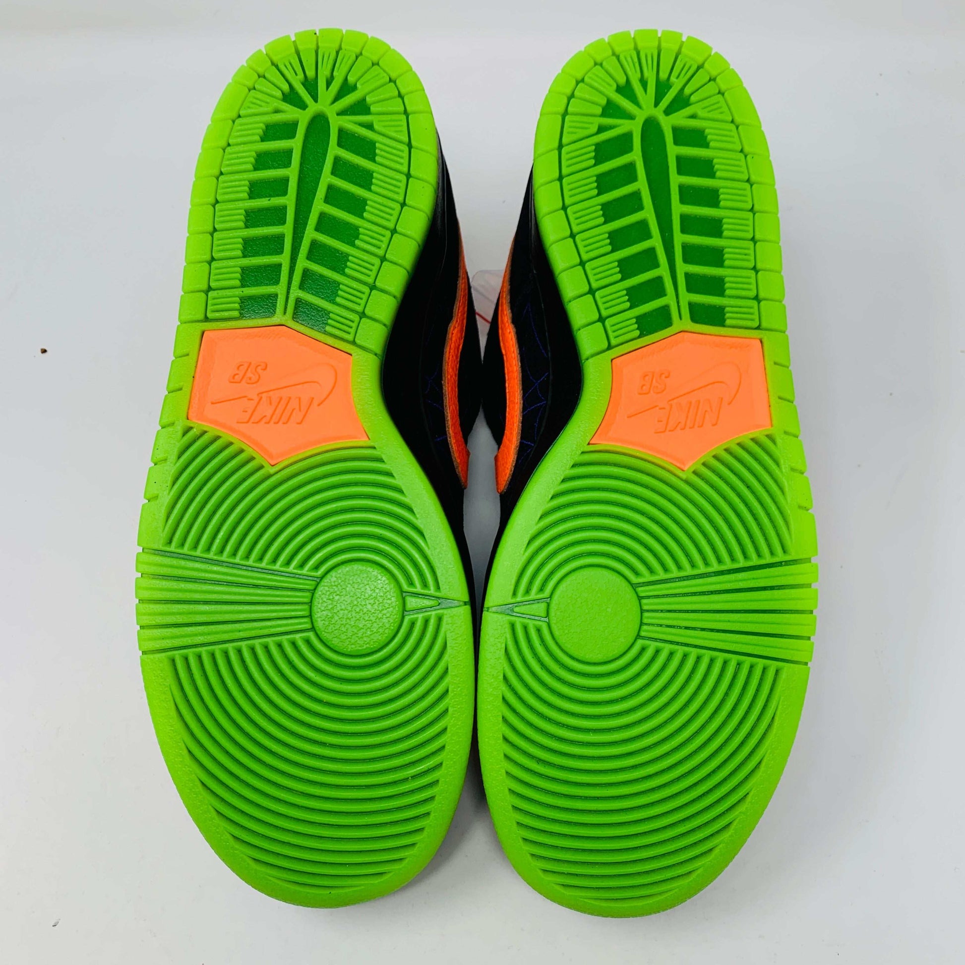 Nike SB Dunk Low Night of Mischief Halloween shoes with bright green soles.
