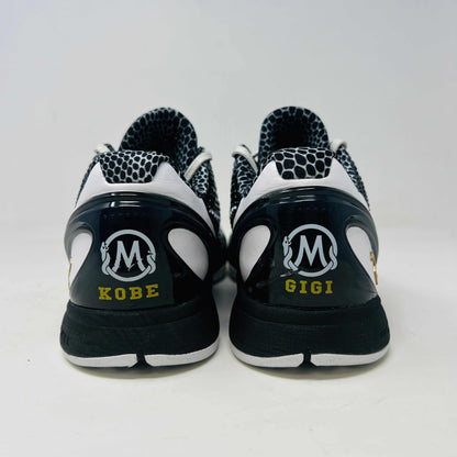 The black and white Nike Kobe 6 Protro Mambacita Sweet 16 shoe features a glossy finish, a gold number 2 on the heel, and light wear with a minor scratch on the back tab. It comes in sizes 8 and 9.5, displayed on a black box labeled Kobe V Proto, and is guaranteed authentic by KOBE.