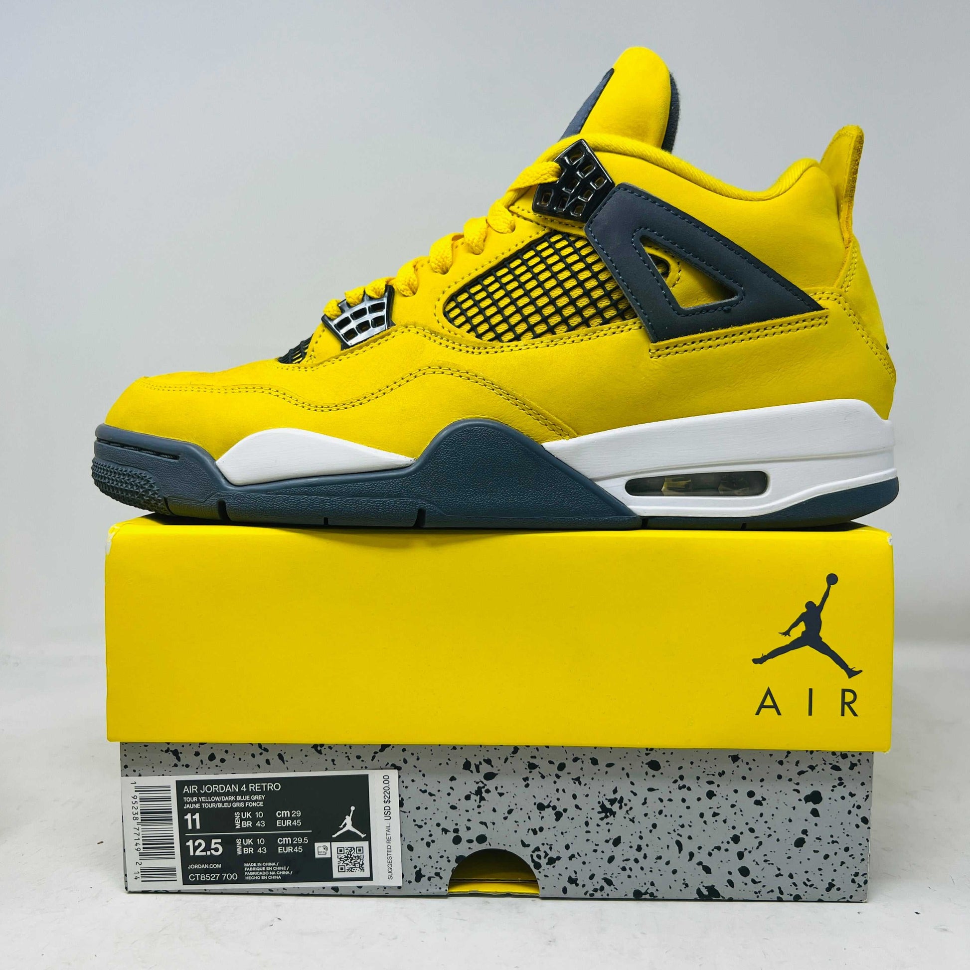 Jordan 4 Retro Lightning 2021 yellow and black sneaker on matching box with air cushioning and classic design