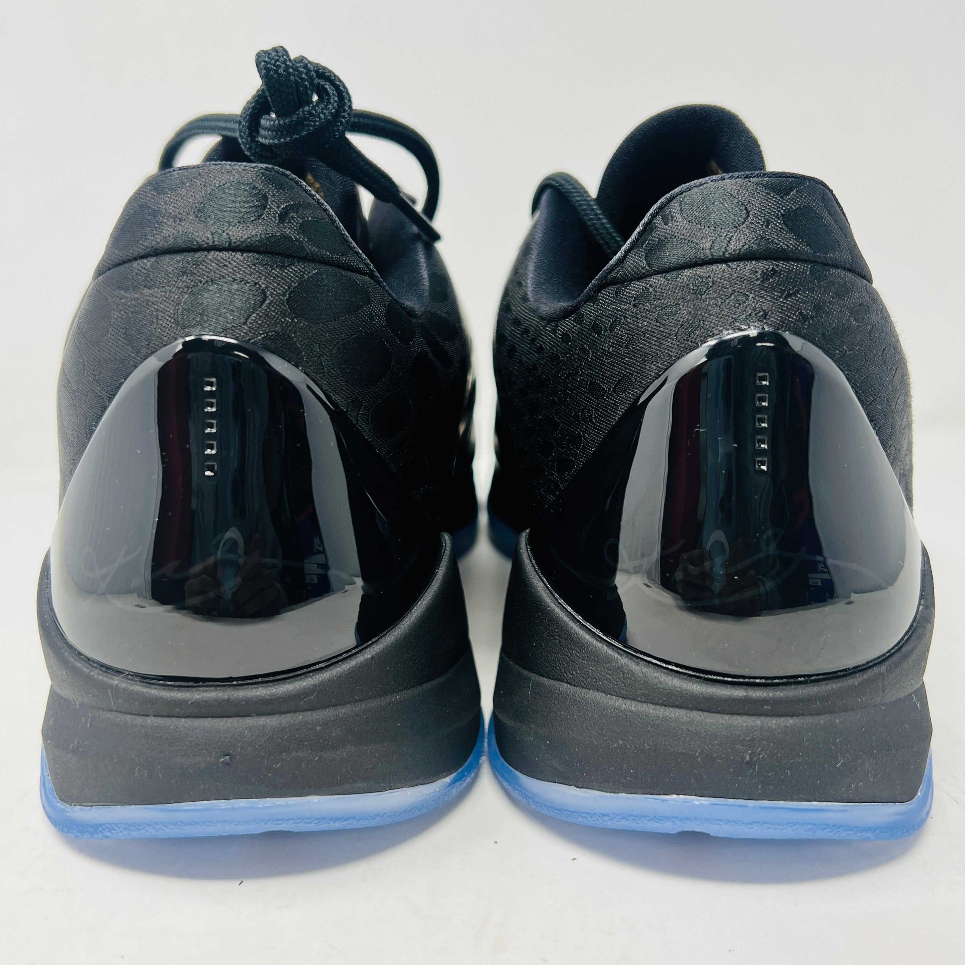 The Nike Kobe 5 Protro Year of the Mamba Eggplant sneakers offer a stylish design with purple and gold colors, black laces, and an authentic tongue logo. They feature perforated side panels, a shiny finish, and include a dust bag for easy storage.