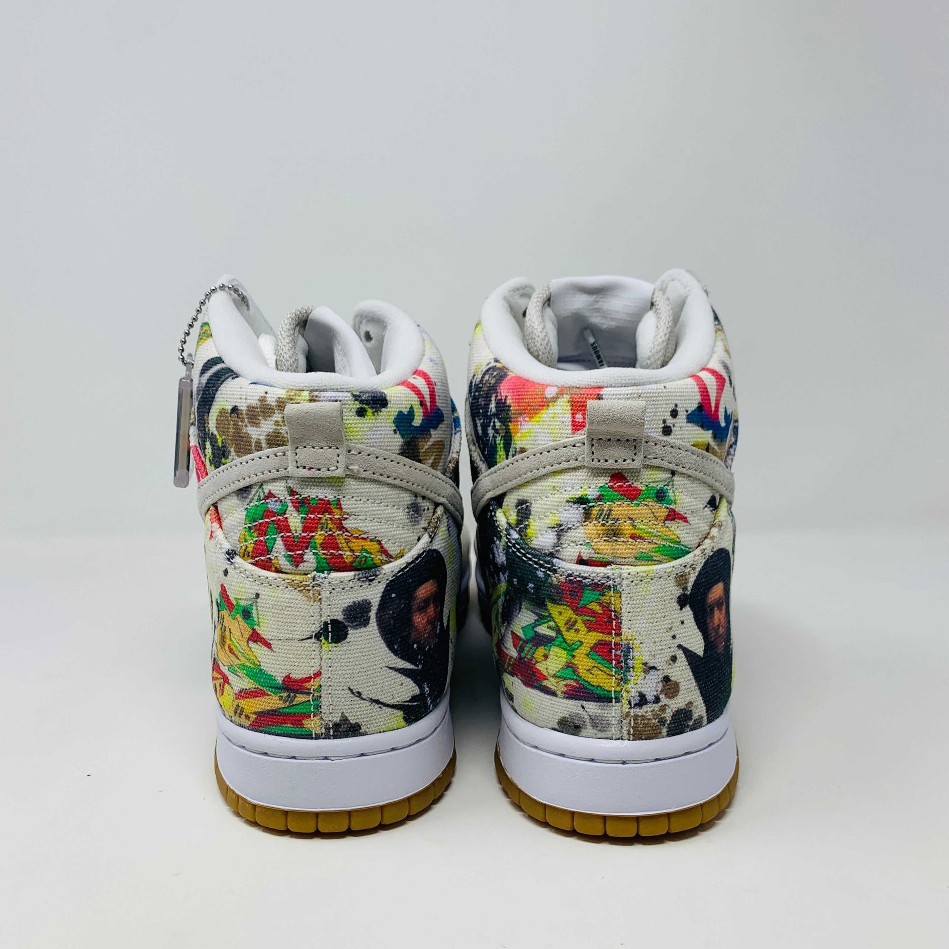 The Nike SB Dunk High Supreme Rammellzee, a 2023 release, sports a vibrant, abstract design. It features an off-white upper with a gum sole and sits atop a Nike SB shoe box. A World Famous tag affirms authenticity, making it ideal for collectors and enthusiasts.