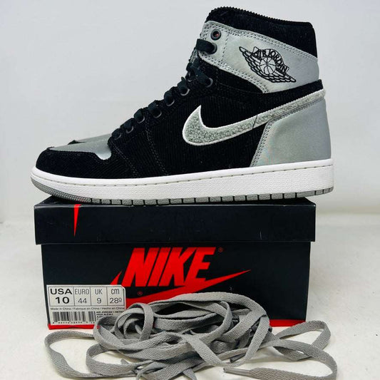 Jordan 1 Retro High Aleali May Shadow sneaker on Nike box with extra laces, black and grey design.
