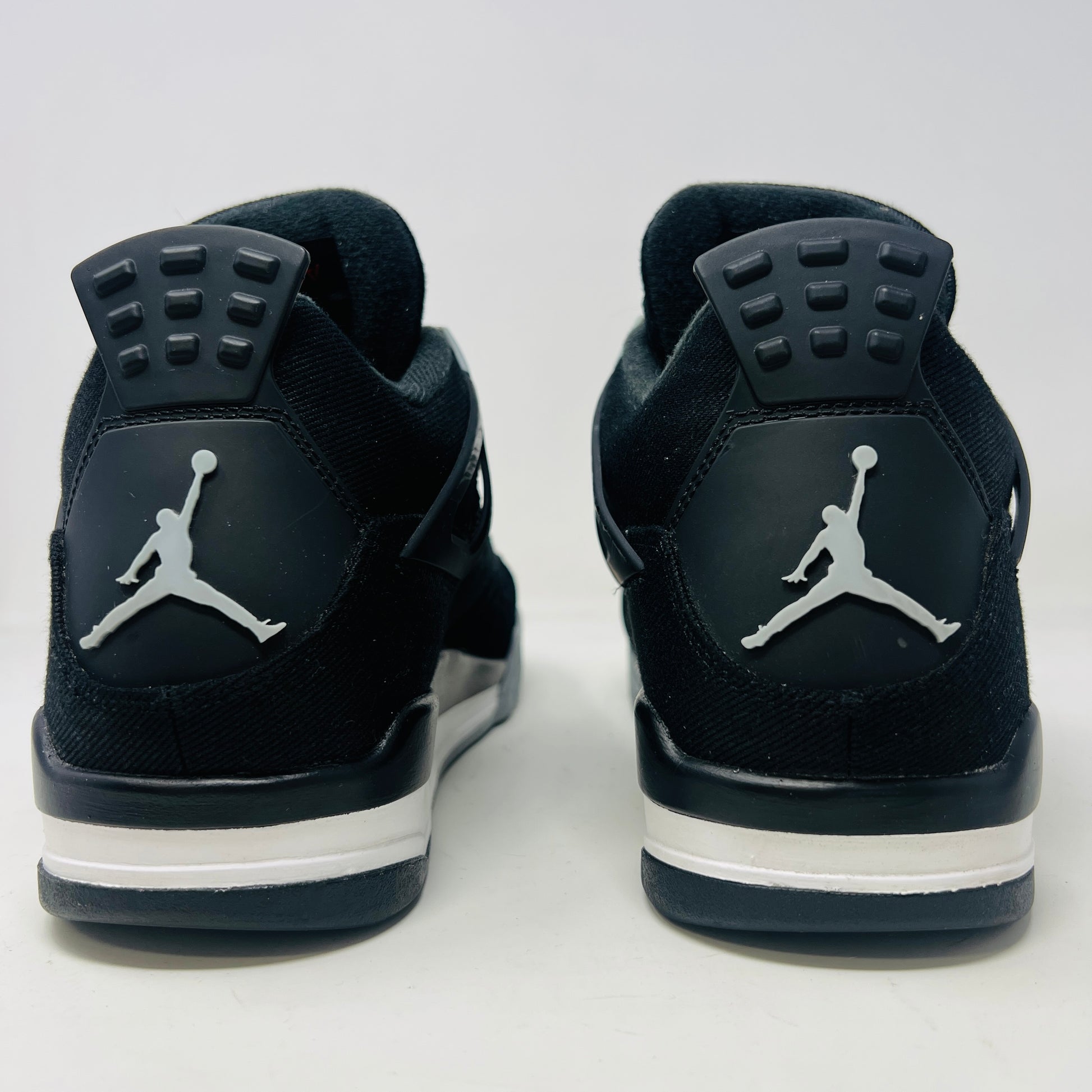 Jordan 4 Retro SE Black Canvas sneakers on box, slight wear.