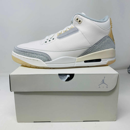 Jordan 3 Retro Craft Ivory sneaker on box showcasing classic design and craftsmanship.