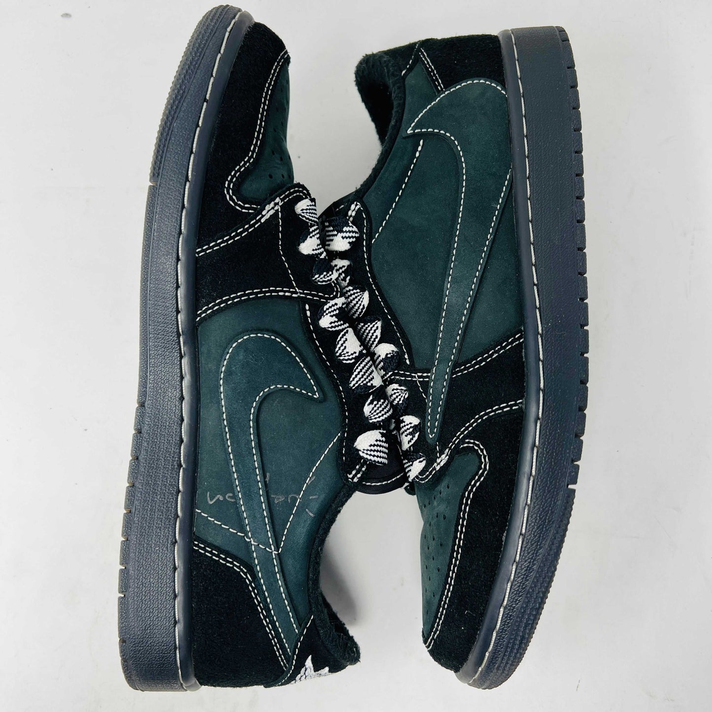 A side view of the Jordan 1 Retro Low OG SP Travis Scott Black Phantom sneaker in black and dark gray with white stitching, size 9.5, displayed on a box with clean uppers and extra laces. A blue sticker shows A2301, with the box label priced at $945.