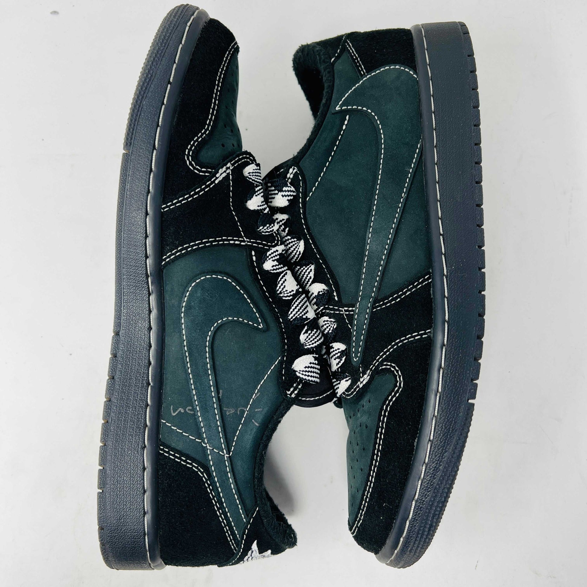 A side view of the Jordan 1 Retro Low OG SP Travis Scott Black Phantom sneaker in black and dark gray with white stitching, size 9.5, displayed on a box with clean uppers and extra laces. A blue sticker shows A2301, with the box label priced at $945.
